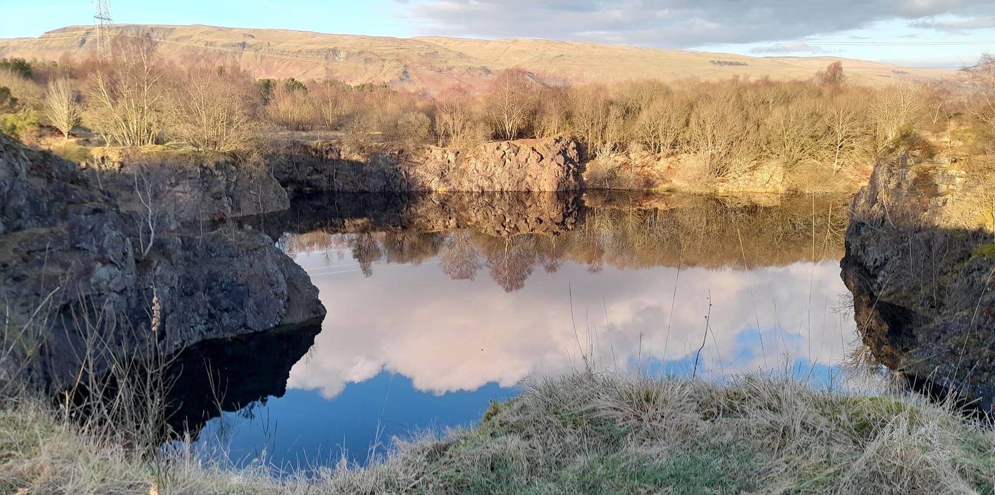 Campsie Fells beyond Peitches Moor and quarry loch in Mugdock Country Park